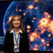 Rosaly Lopes, Brazilian planetary scientist at NASA's Jet Propulsion Laboratory, studying infrared images of volcanic hotspots on Jupiter's moon Io, holding a Guinness World Record for discovering 71 active volcanoes
